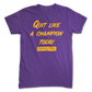 A Quit Like A Champion t-shirt. It's purple. And it has yellow text with "QUIT LIKE A CHAMPION" and the Defector logo in yellow.