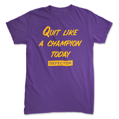 A Quit Like A Champion t-shirt. It's purple. And it has yellow text with "QUIT LIKE A CHAMPION" and the Defector logo in yellow.