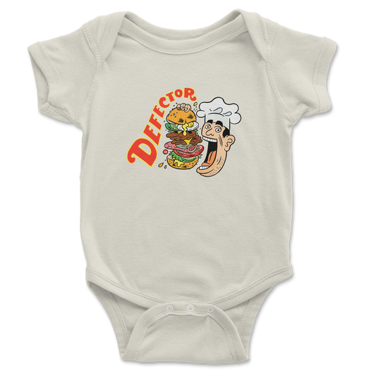 A baby onesie with a chef eating a giant sandwich and it says DEFECTOR