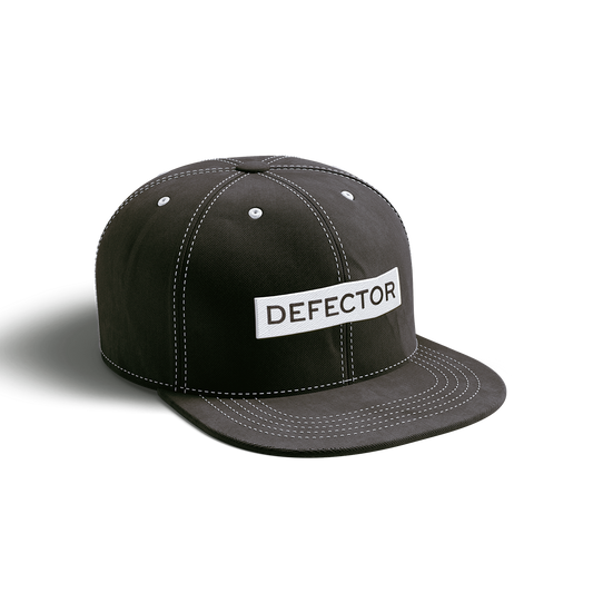 This is a black baseball cap with white stitching. It features a three-inch wide "DEFECTOR" logo stitched, white logo with black text.