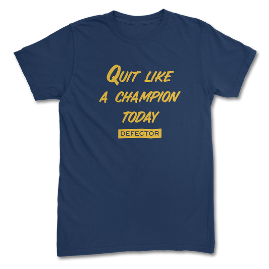 A Quit Like A Champion t-shirt. It's navy blue. And it has yellow text with "QUIT LIKE A CHAMPION" and the Defector logo in yellow.