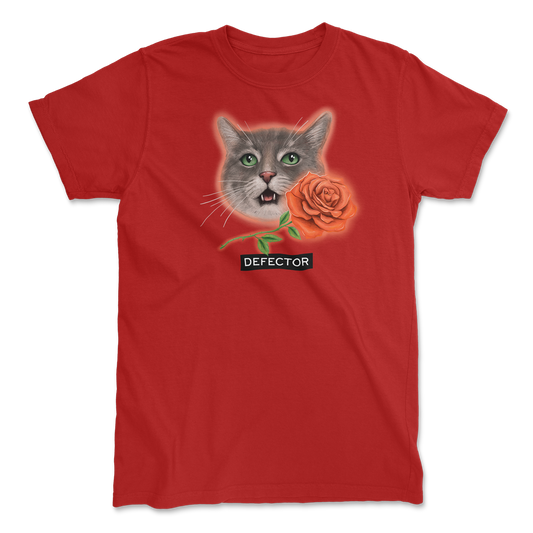 Very photogenic cat drawing. The cat is grey with white markings and some tabby colors. There is a red rose and the Defector logo under it. RED SHIRT